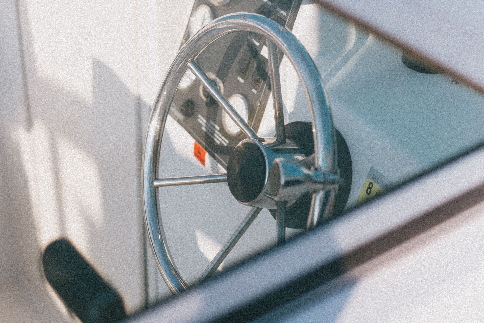 Polished chrome and stainless helm on a freshly detailed boat